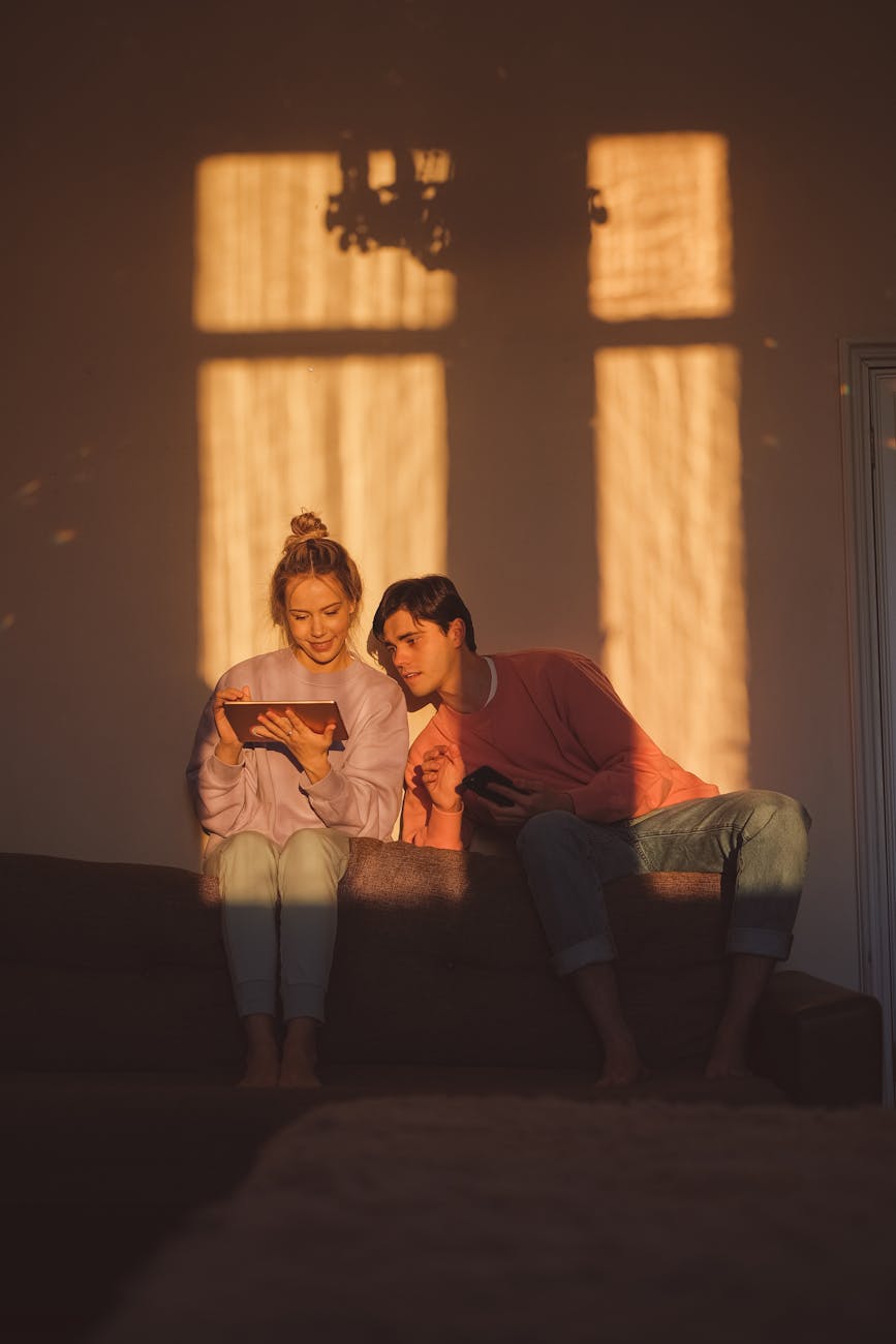 man and woman sitting on the couch