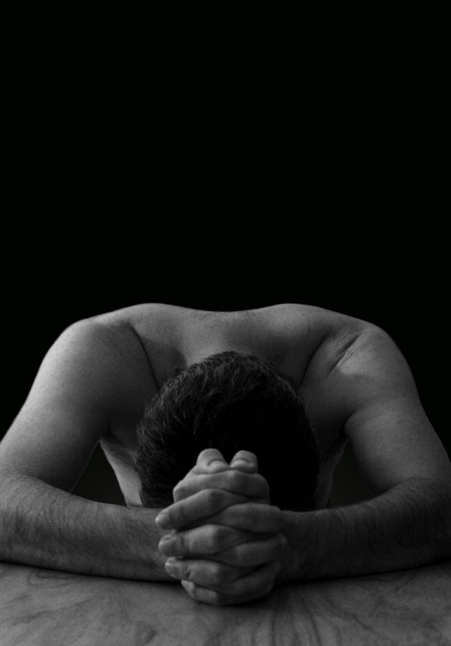 shirtless man bowing down